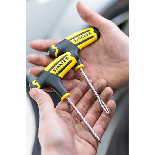 Photo of STANLEY STHT80891-0 T-handle screwdriver set with black and yellow grips held in hands.