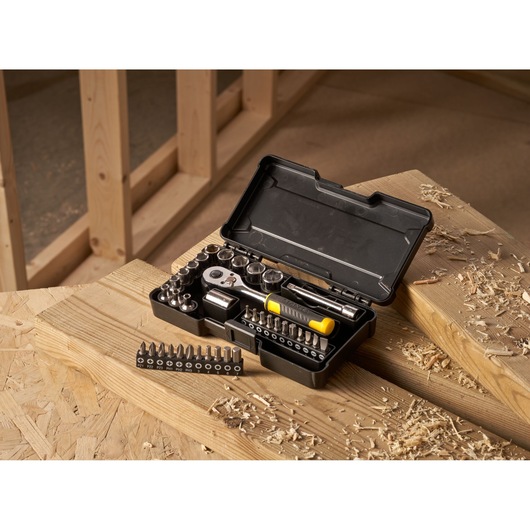 STANLEY STMT82672-0 compact ratchet and socket set with accessories, 37 pieces, in open case on workshop table.