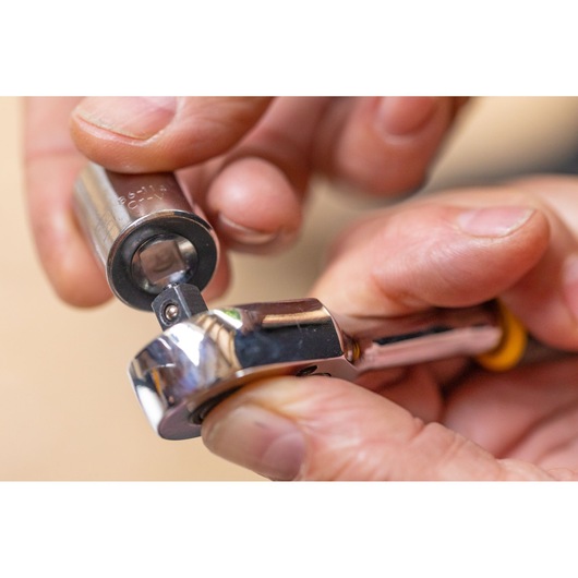 STANLEY STMT86112-0 photography of socket being attached to ratchet wrench close-up.