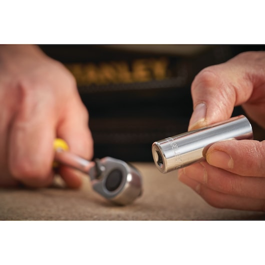 STANLEY STMT86289-0 socket held in hand with ratchet wrench, close-up, tool in use.