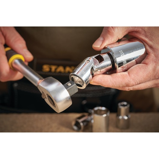 Photo of STANLEY STMT86411-0 ratchet and socket tool in use, chrome finish, close-up.
