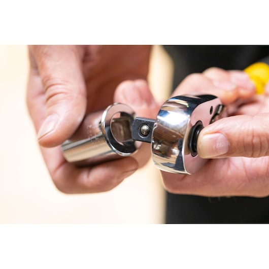 STANLEY STMT86514-0 ratchet with socket held in hand, close-up showing attachment mechanism.
