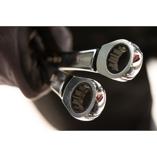 STANLEY STMT89908-0 photography of two chrome ratcheting wrenches held in a gloved hand, close-up view.