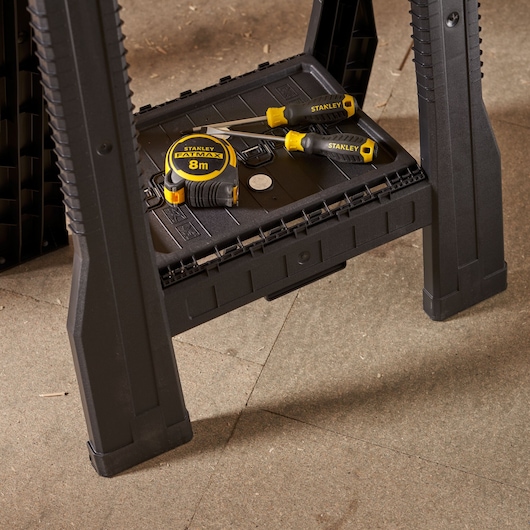 STANLEY STST1-70713 black workbench shelf with tape measure and screwdrivers, side angle.