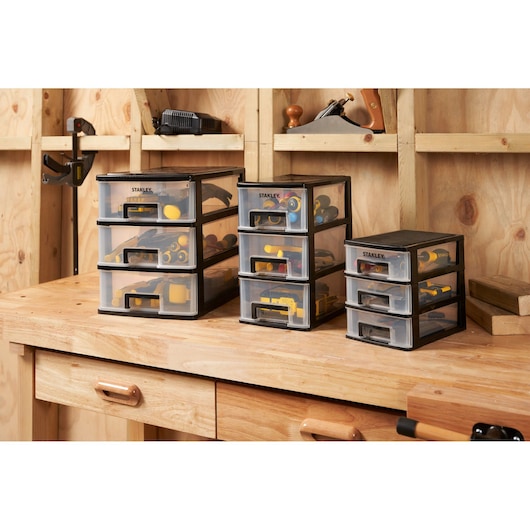 Photo of STANLEY STST40711-1 drawer organizers with tools on a wooden workbench in a workshop.