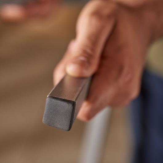 STANLEY STST81337-1 square metal bar held in hand, close-up photography.
