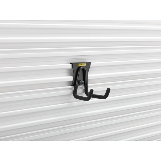 Photo of STANLEY STST82607-1 black wall-mounted utility hook on white panel, side angle.