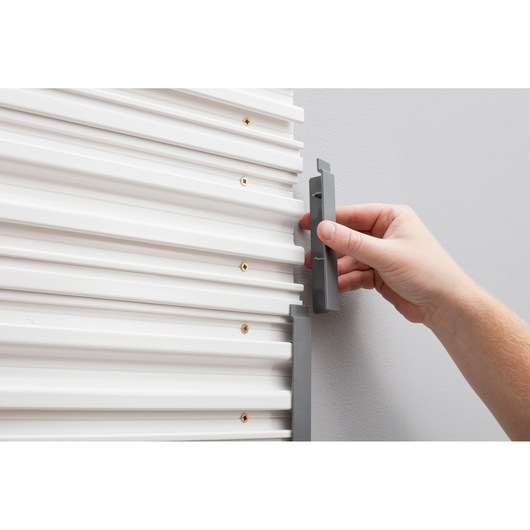 STANLEY STST82611-1 grey end cap being installed on white wall panel, close-up photography.