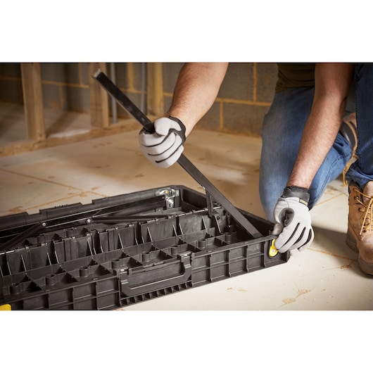 STANLEY STST83492-1 tool organizer being opened on floor, black plastic case with compartments.