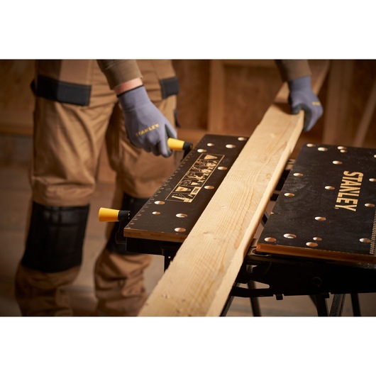 STANLEY STST83800-1 workbench holding wooden plank, close-up, photo of product in use.