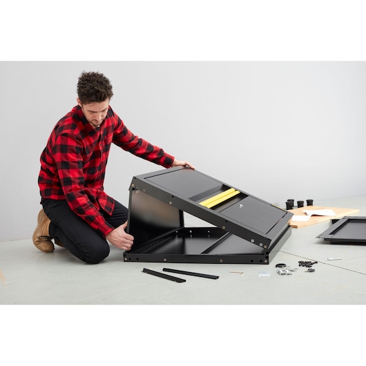 STANLEY STST97595-1 metal cabinet assembly in progress, black panels, yellow handle, accessories visible.
