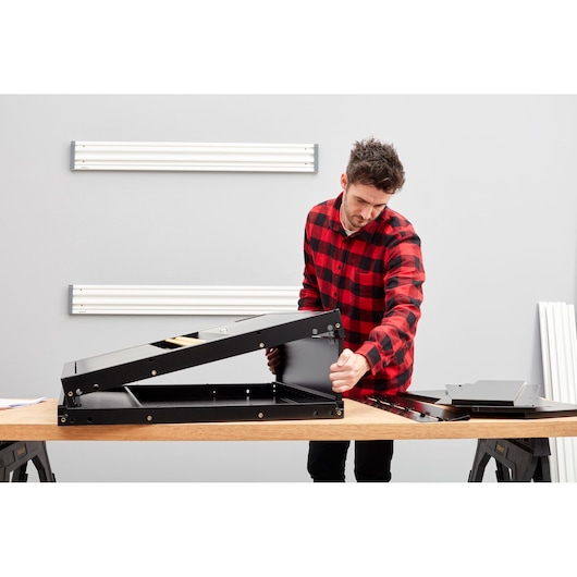 STANLEY STST97598-1 black metal tool organizer assembly on workbench in workshop setting.